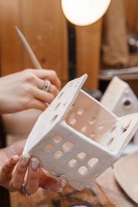 A master ceramist holds a clay product in his hands. making a ceramic candle holder from clay. 