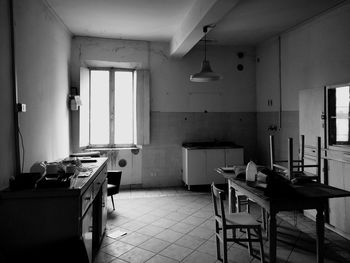 Empty chairs and tables in room