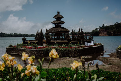 Panoramic view of temple by building against sky