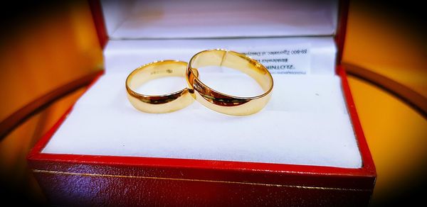 Close-up of wedding rings on table