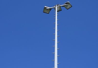 Low angle view of street light against clear blue sky