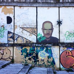 Man standing by graffiti