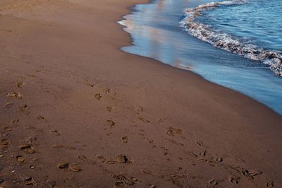 High angle view of footprints on beach