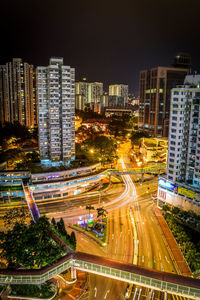 High angle view of illuminated city street and buildings at night