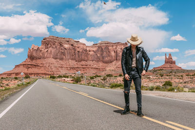 Man standing on road against sky