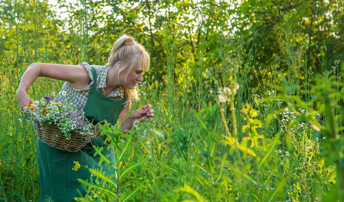 Portrait of young woman standing on field