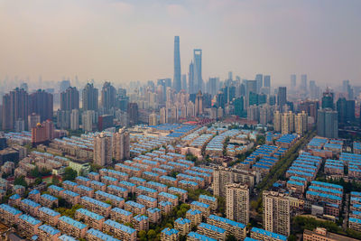 Aerial view of modern buildings in city against sky