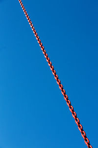 Low angle view of metallic structure against clear blue sky
