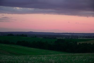 Scenic view of field against sky during sunset