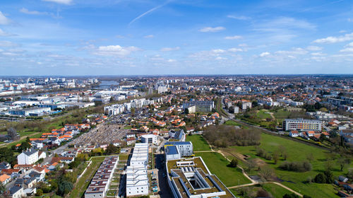 High angle view of townscape by sea against sky