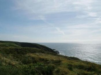 Scenic view of sea against cloudy sky