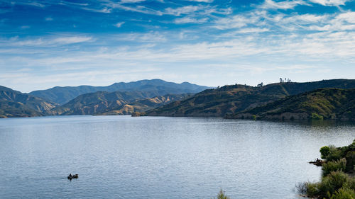 Scenic view of lake and mountains against sky