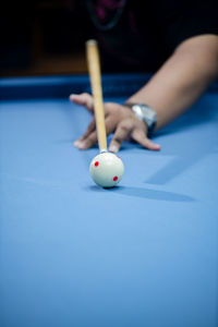 Midsection of man playing pool