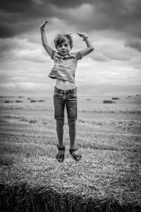 Full length of boy standing on field