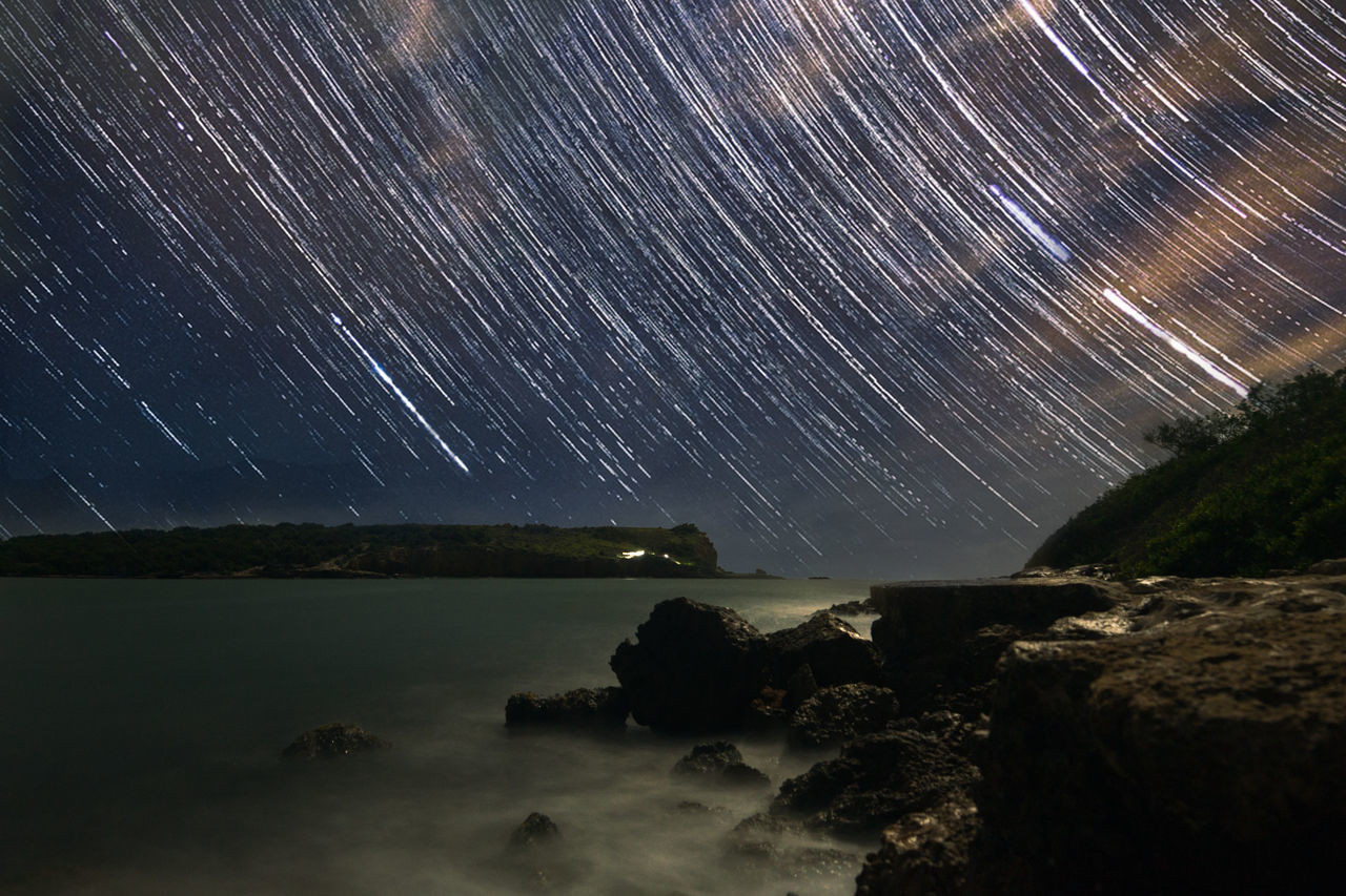 SCENIC VIEW OF STAR TRAILS AT NIGHT