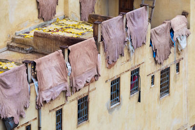 Low angle view of clothes drying on old building