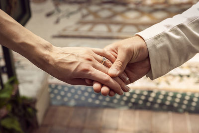 High angle view of newlywed couple holding hands