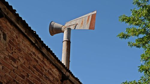 Low angle view of old building against clear blue sky