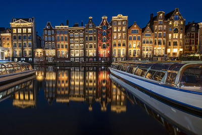 Reflection of buildings in river at night