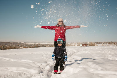 Full length of person on snow covered field against sky