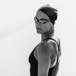 Portrait of woman in swimwear against swimming pool