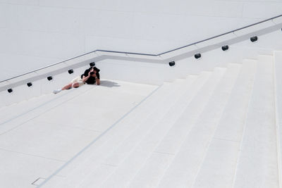 High angle view of man photographing with camera on steps