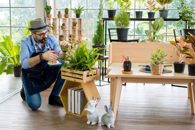 Men sitting on potted plant