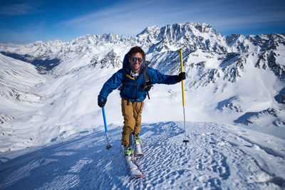 Full length of man standing on snowcapped mountain