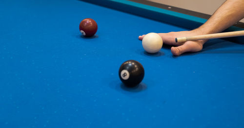 Cropped hand playing pool