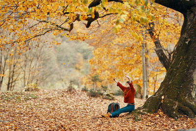 Man sitting in park during autumn