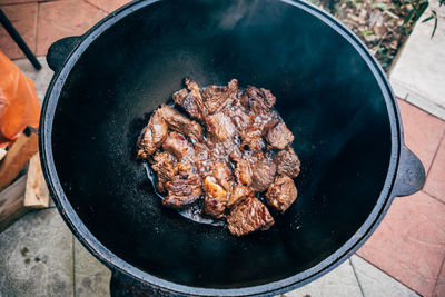 High angle view of meat on barbecue grill