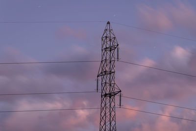 Low angle view of electricity pylon against sky