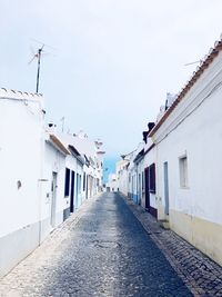 Street amidst buildings against sky