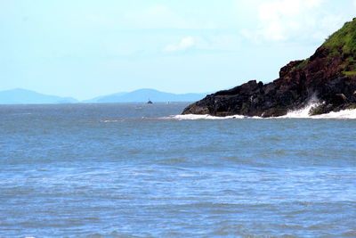 Scenic view of sea and mountains against sky