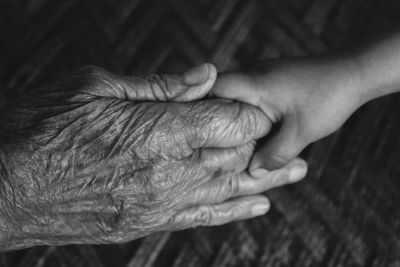 Cropped image of people holding hands