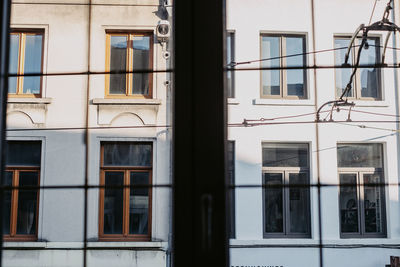 Low angle view of building through window 