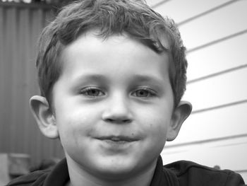 Close-up portrait of boy in yard