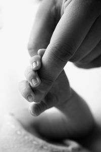 Baby holding man's finger