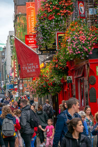 Group of people walking on street in city