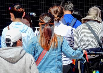 Rear view of people enjoying music in city