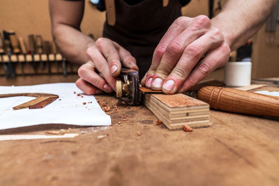 Midsection of man working on table