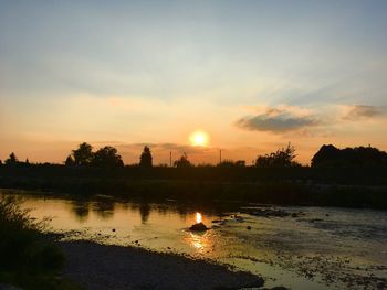 Scenic view of lake against sky during sunset