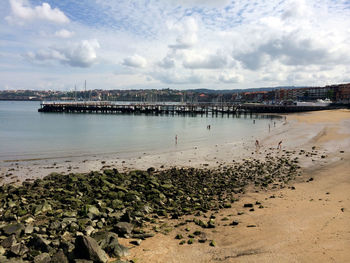 View of beach against cloudy sky