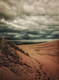 Scenic view of landscape against cloudy sky