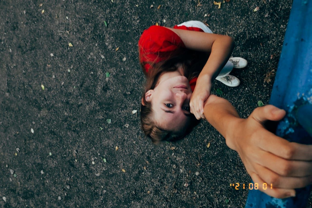 blue, child, fun, lying down, high angle view, one person, red, men, childhood, person, emotion, portrait, leisure activity, human face, lifestyles, young adult, day, nature, directly above, adult, casual clothing, outdoors, clothing, toddler, hand, lying on back, women, relaxation