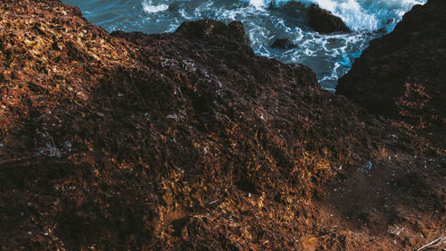 High angle view of rocks on sea shore