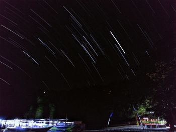 Low angle view of fireworks against sky at night