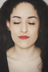 Young woman with eyes closed