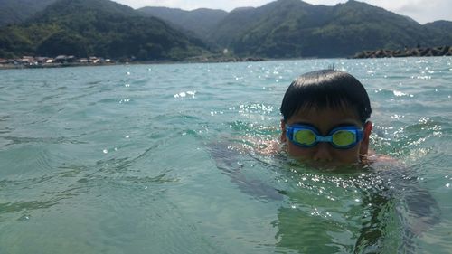 Portrait of boy swimming in sea