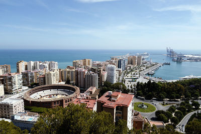 High angle view of buildings and sea against sky